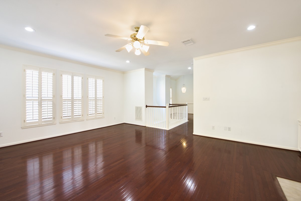 918 Cohn Street Houston, TX 77007 - Photo 6 of 32 a view of an empty room with a window and wooden floor