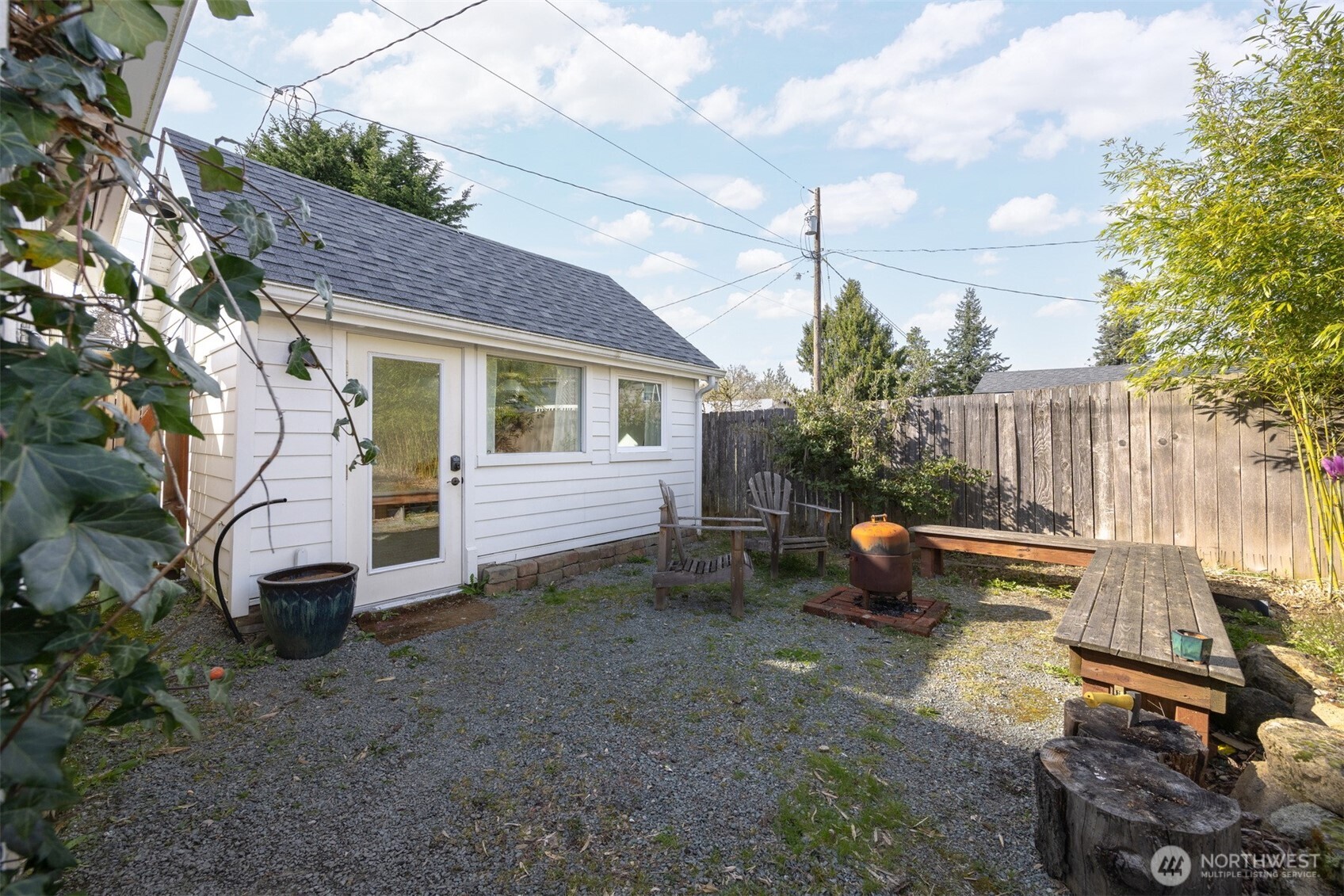 1205 Humboldt Street Bellingham, WA 98225 - Photo 29 of 40 a view of a chairs setting in the backyard with large tree