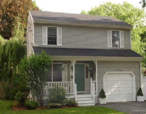 121 Henderson Road Fairfield, CT 06824 - Photo 1 of 1 a front view of a house with a yard and trees