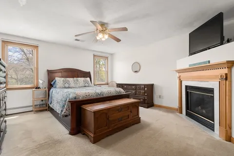 a spacious bedroom with a bed and a fireplace