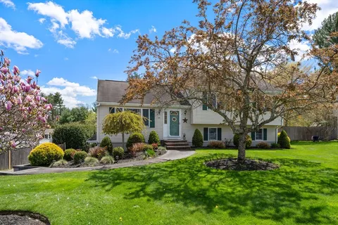 a view of a house with backyard sitting area and garden