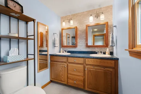 a bathroom with a sink a vanity and a mirror