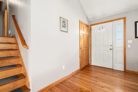 a view of a hallway with wooden floor and entryway