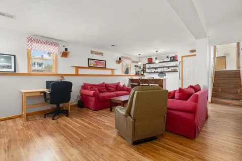 a living room with furniture window and a wooden floor