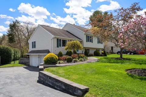 a front view of house with yard and outdoor seating