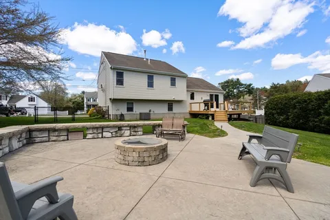 a view of a patio with dining table and chairs with a fire pit and a fire pit