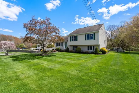 a view of house with outdoor space and sitting area