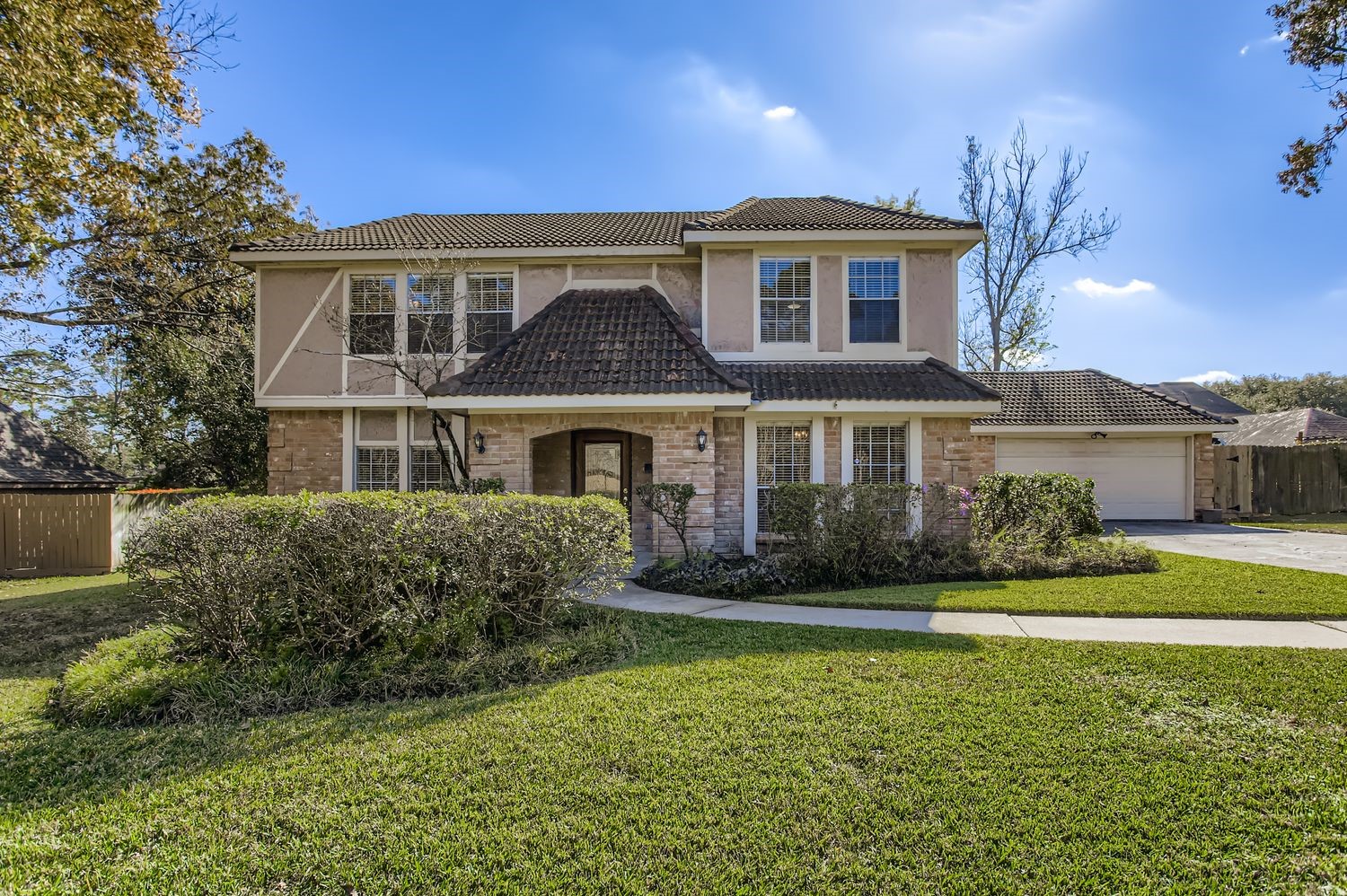 Discover your dream home at 8518 Rebawood Dr in Pinehurst Atascocita: a charming two-story with lush landscaping and classic architectural appeal.
