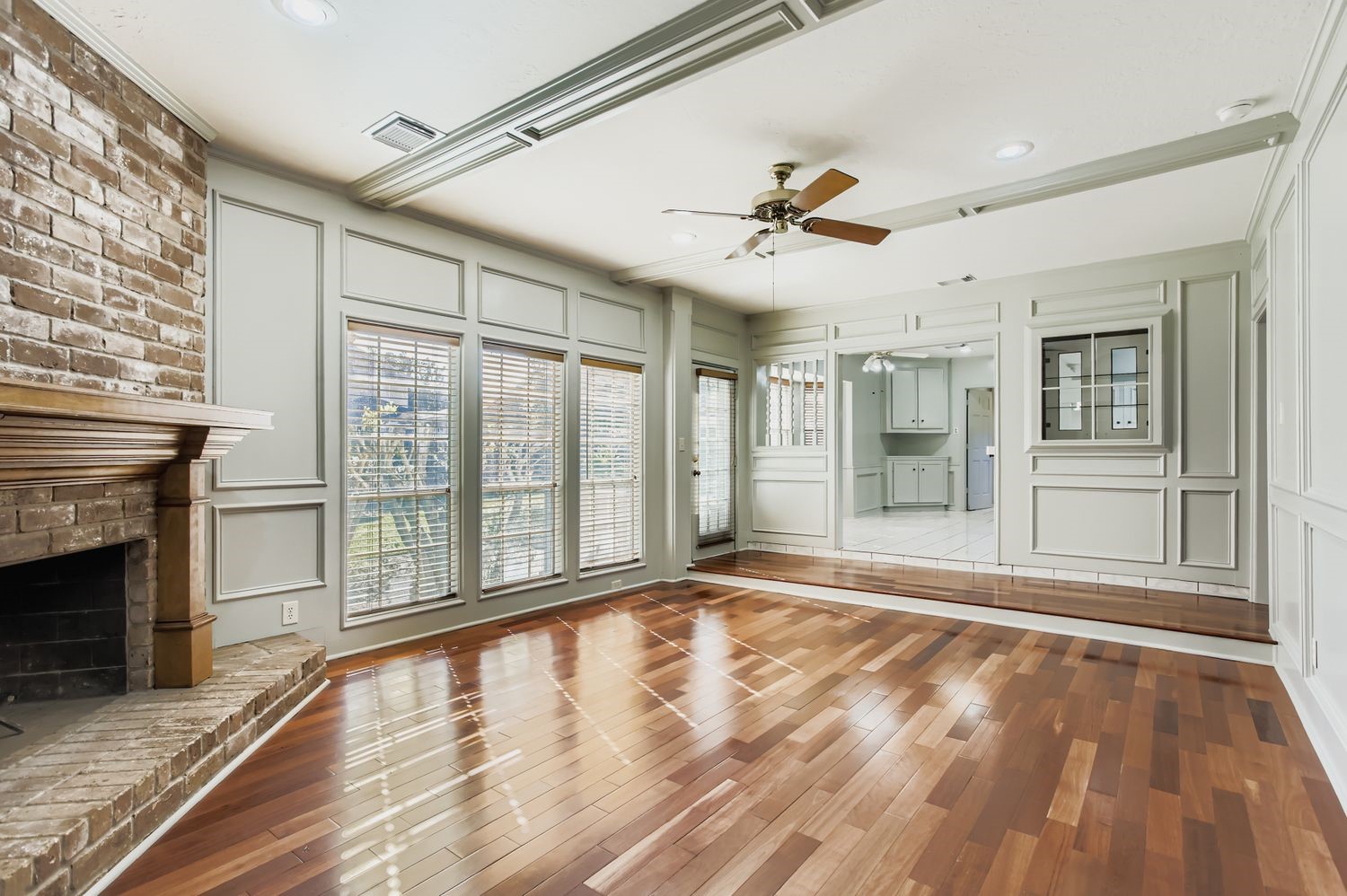 8518 Rebawood Drive Humble, TX 77346 - Photo 13 of 36 Experience the warmth and elegance of this inviting living room as it seamlessly flows into a bright kitchen and breakfast area, perfect for family gatherings and relaxed mornings.