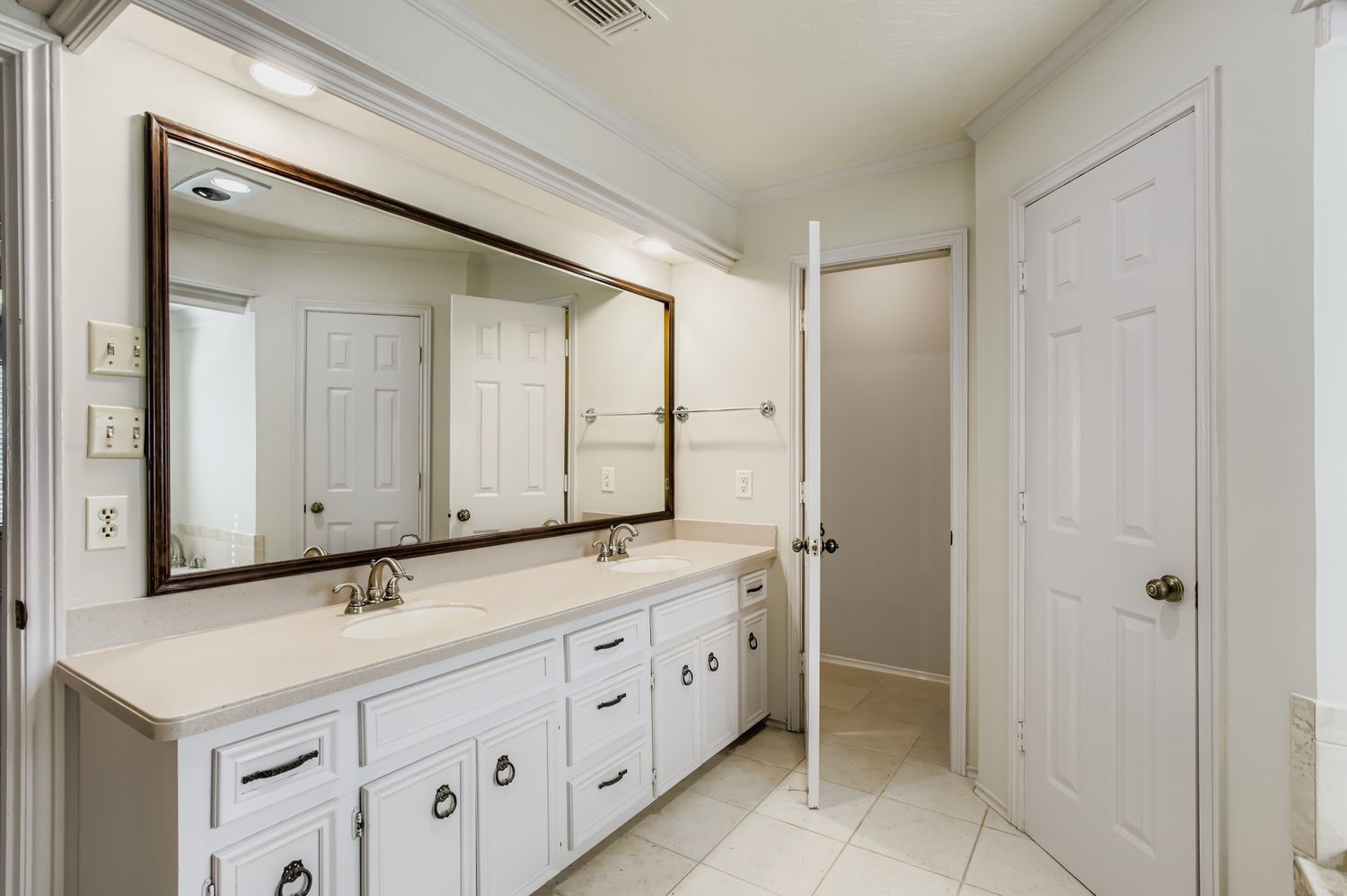 8518 Rebawood Drive Humble, TX 77346 - Photo 18 of 36 Experience the luxury of a primary bathroom with dual sinks, two spacious closets, a private toilet area, and ample storage for ultimate convenience and comfort.