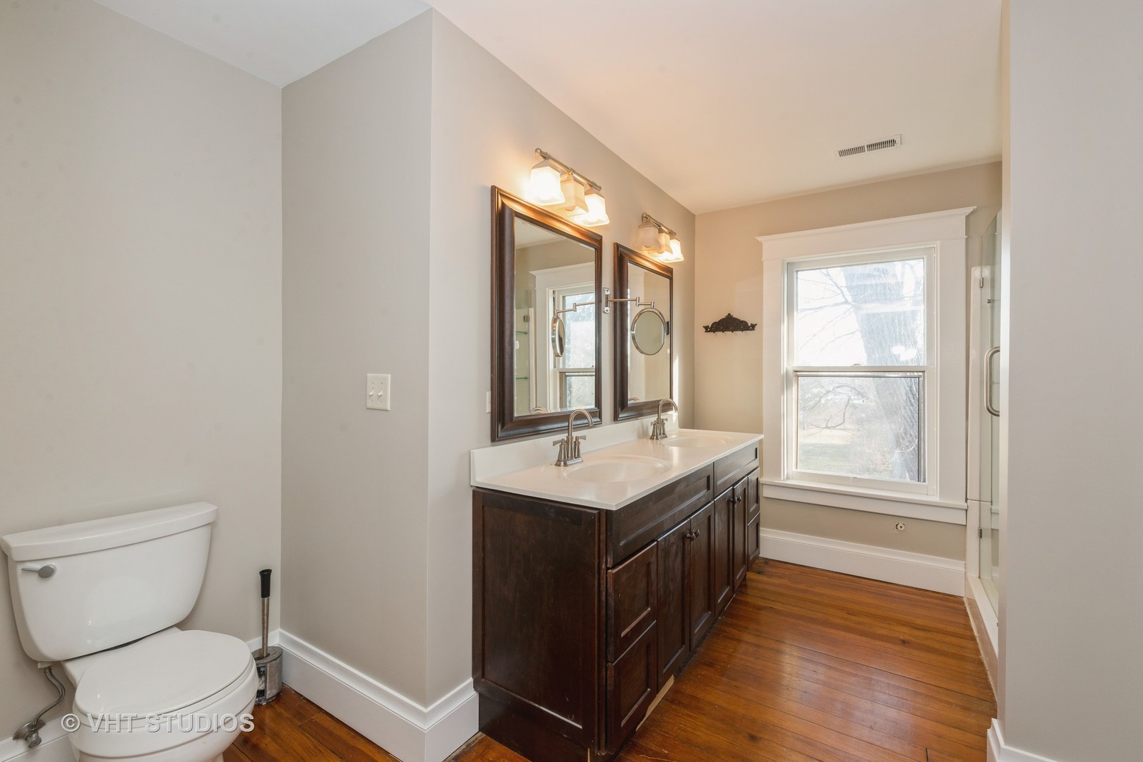 2N100 Brundige Road Elburn, IL 60119 - Photo 19 of 34 a bathroom with a granite countertop toilet a sink and a window