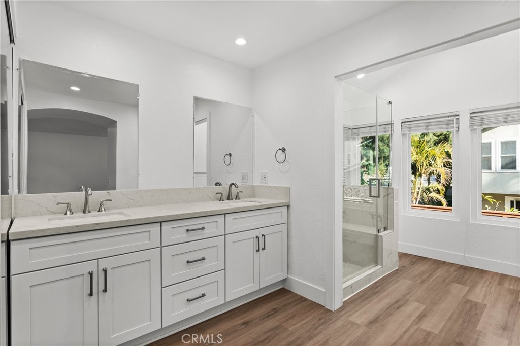 16 Encina Irvine, CA 92620 - Photo 20 of 37 a spacious bathroom with double vanity and a mirror