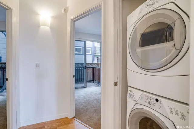a view of a hallway with washer and dryer