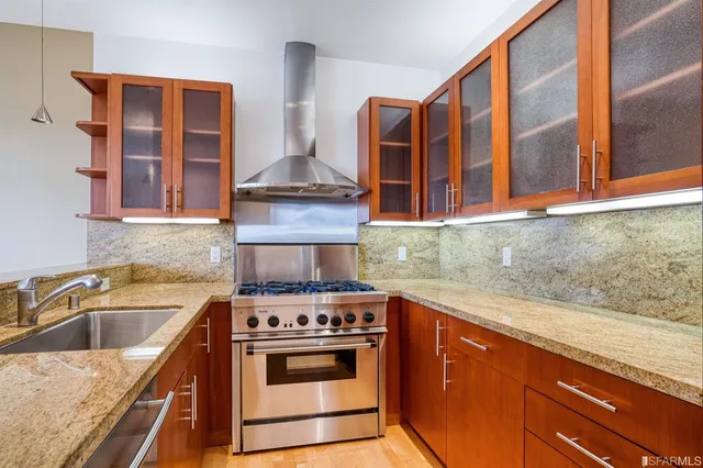 a kitchen with a sink stove and cabinets