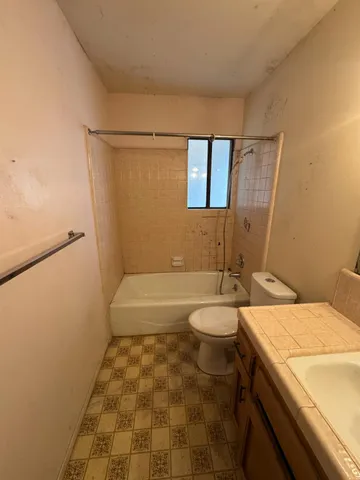 a living room with patio furniture and a window