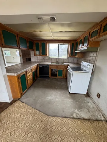 a kitchen with stainless steel appliances granite countertop a sink and stove