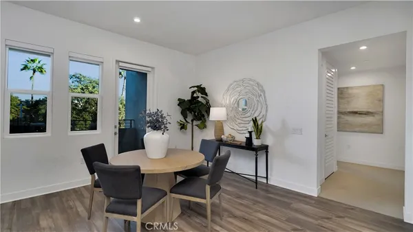 a dining room with furniture and wooden floor