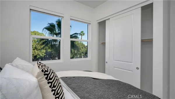 a view of a bedroom with furniture and a window