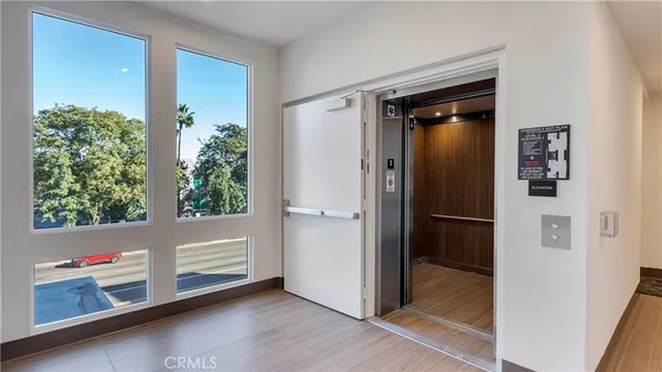 a view of a room with wooden floor and entryway