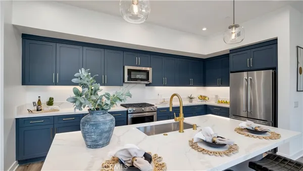a dining room with furniture a chandelier and kitchen view