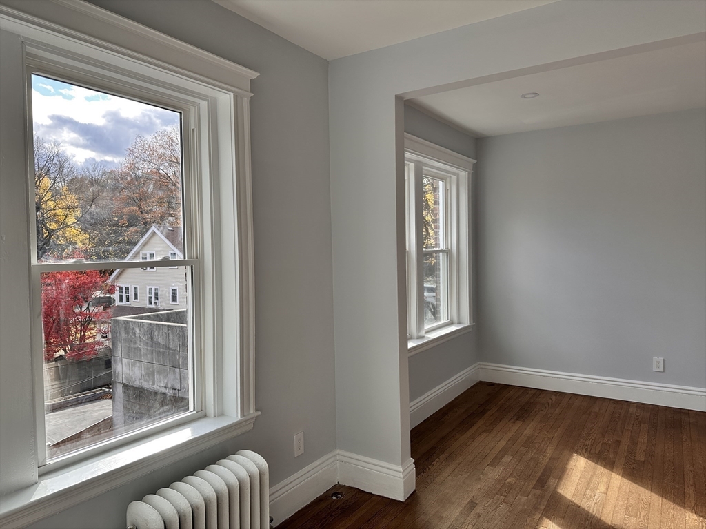 1521 Beacon Street, Unit 1 Brookline, MA 02446 - Photo 11 of 15 a living room with furniture and a window