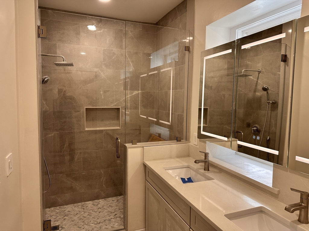 1521 Beacon Street, Unit 1 Brookline, MA 02446 - Photo 12 of 15 a bathroom with a shower sink and mirror