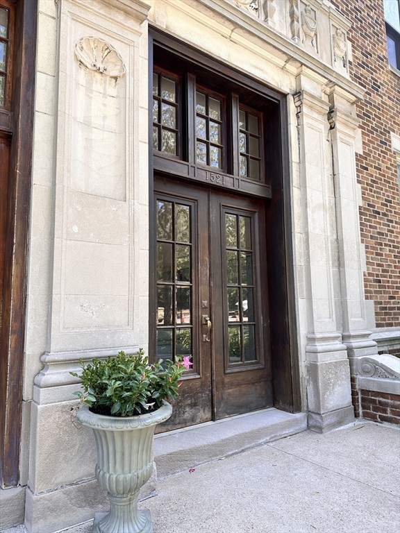 1521 Beacon Street, Unit 1 Brookline, MA 02446 - Photo 2 of 15 a view of a house with a potted plant and a window