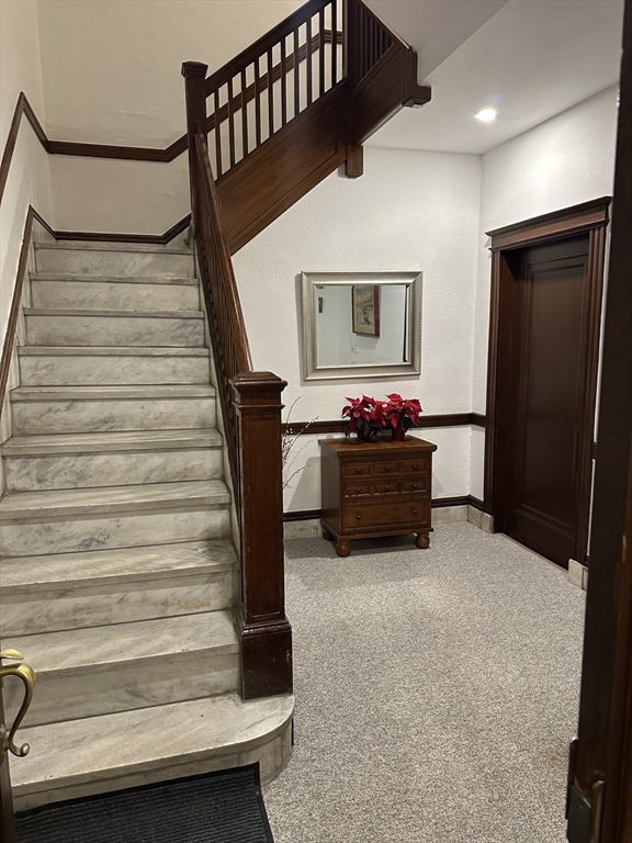 1521 Beacon Street, Unit 1 Brookline, MA 02446 - Photo 3 of 15 a living room with furniture and a stair