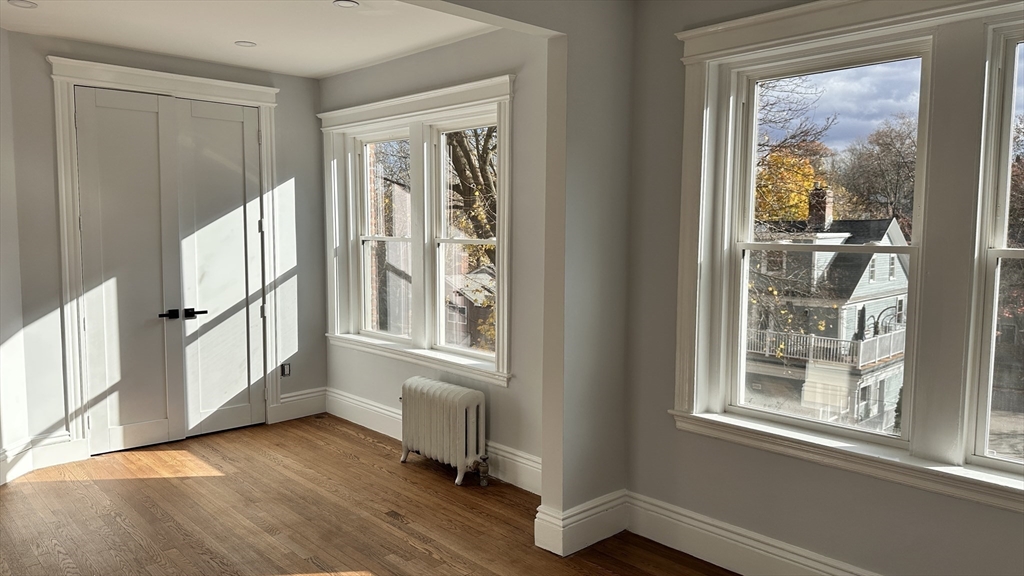 1521 Beacon Street, Unit 1 Brookline, MA 02446 - Photo 10 of 15 a view of an entryway with wooden floor and windows