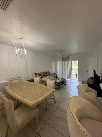 a bedroom with a bed and a view of living room