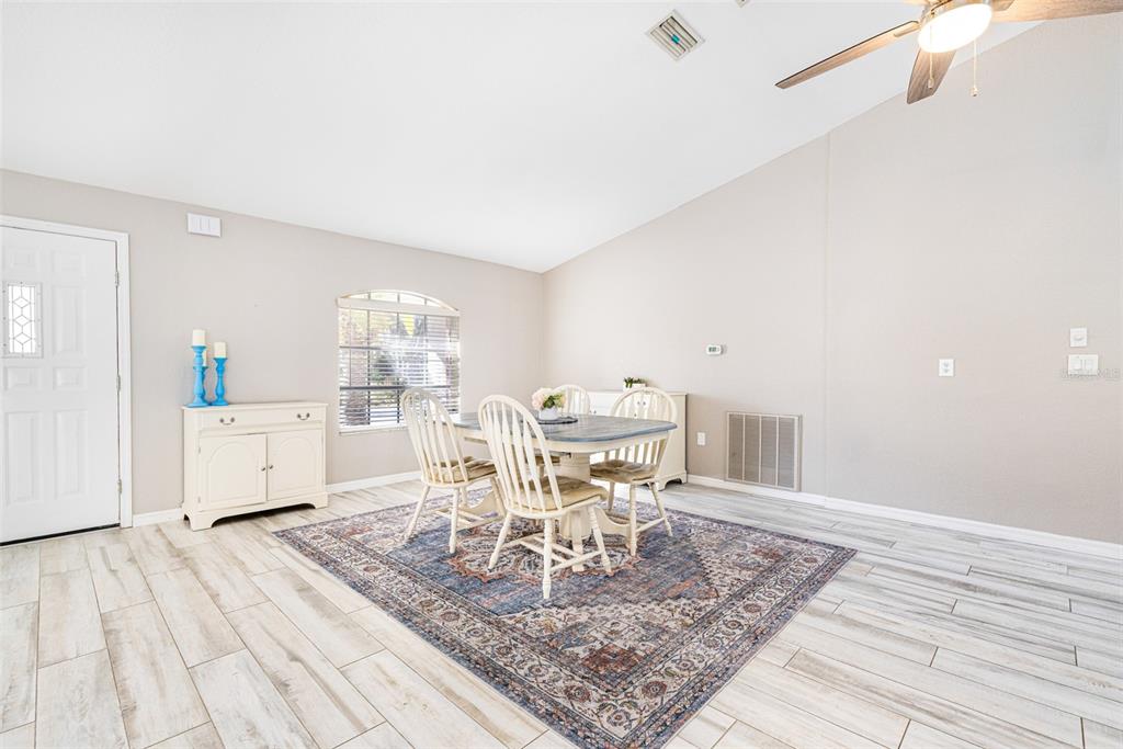 28522 Coco Palm Drive Punta Gorda, FL 33982 - Photo 12 of 54 a view of a dining room with furniture and wooden floor