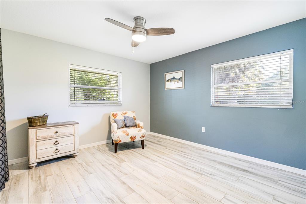 28522 Coco Palm Drive Punta Gorda, FL 33982 - Photo 13 of 54 a bedroom with a bed and a chandelier