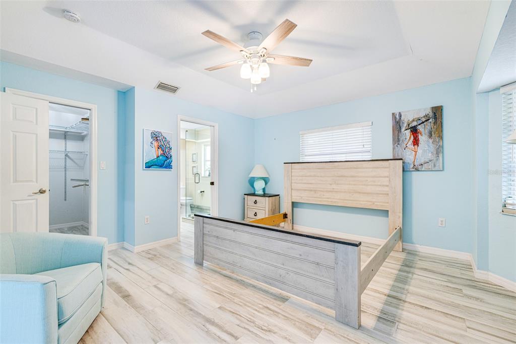 28522 Coco Palm Drive Punta Gorda, FL 33982 - Photo 17 of 54 a bedroom with a bed and a chandelier