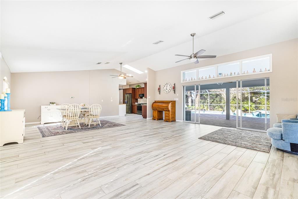 28522 Coco Palm Drive Punta Gorda, FL 33982 - Photo 4 of 54 a spacious bedroom with a bed a table window and couch
