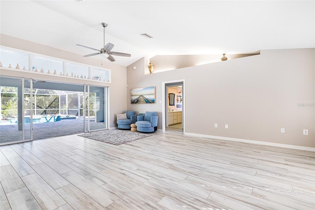 28522 Coco Palm Drive Punta Gorda, FL 33982 - Photo 5 of 54 a view of a room with wooden floor and windows