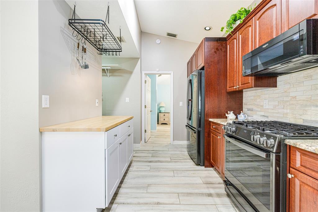 28522 Coco Palm Drive Punta Gorda, FL 33982 - Photo 6 of 54 a kitchen with granite countertop a stove and a refrigerator