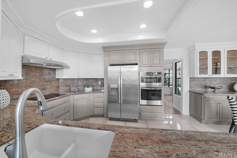 23 Coventry Newport Beach, CA 92660 - Photo 11 of 16 a kitchen with granite countertop a refrigerator and a sink