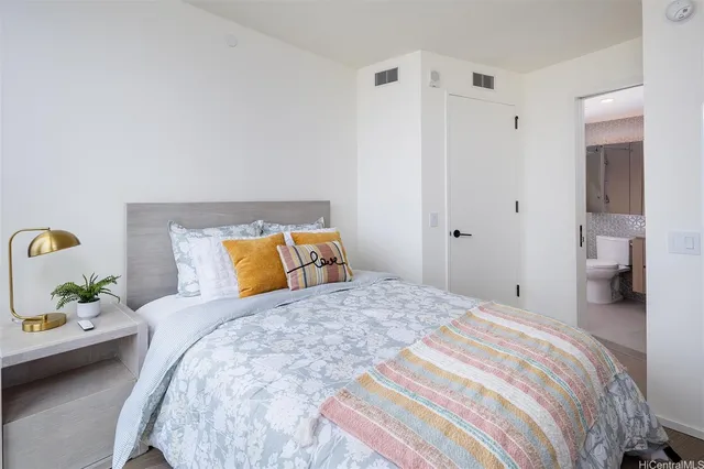 a bedroom with a bed and a lamp