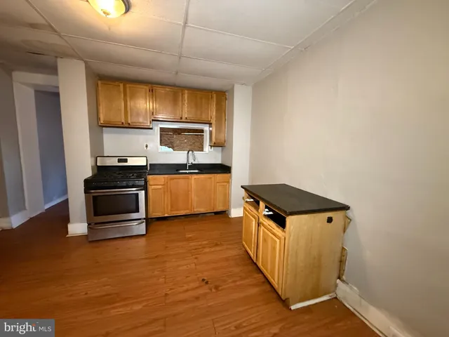 a kitchen with granite countertop a stove and a refrigerator