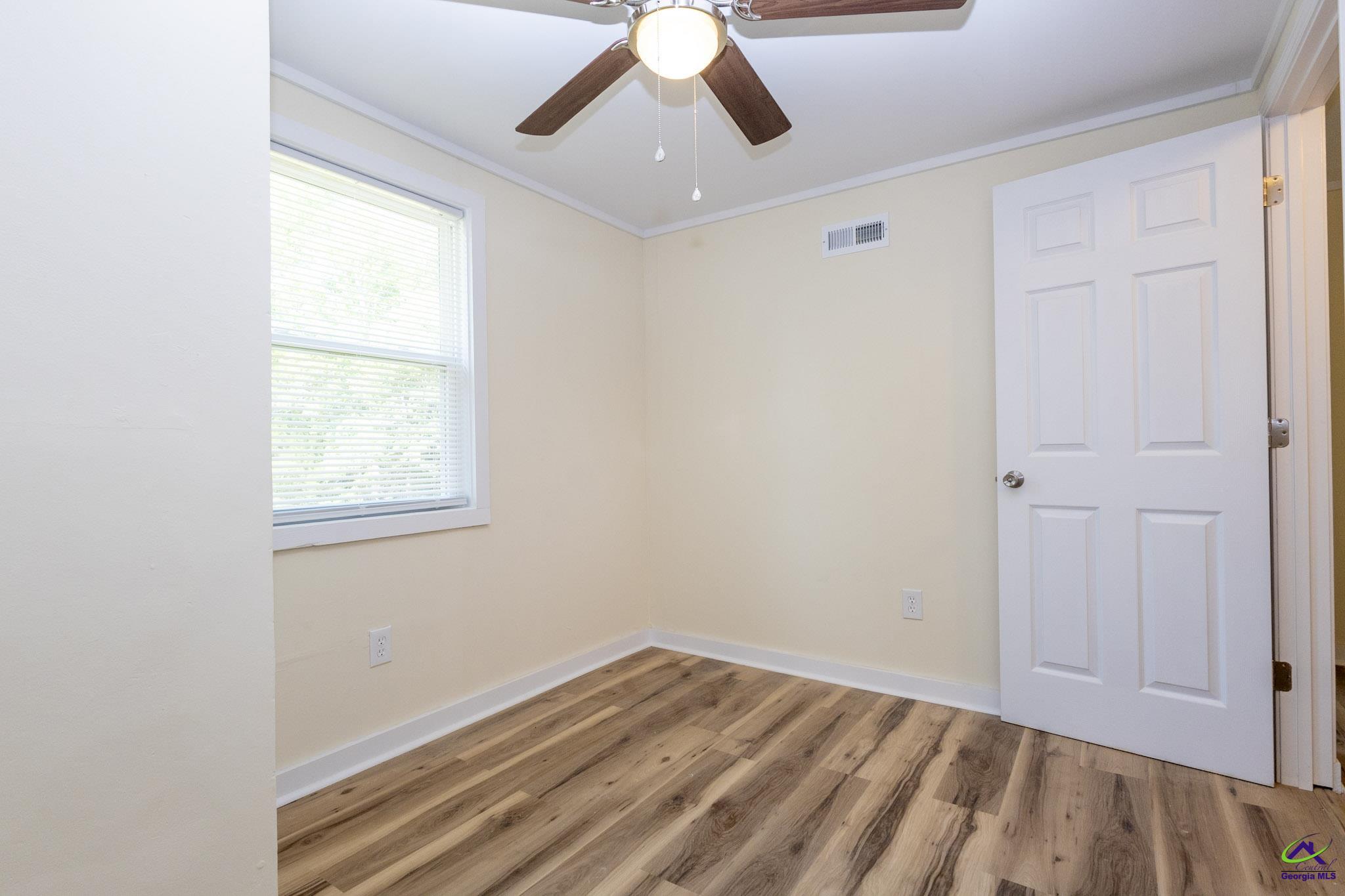 156 Churchwell Road Cochran, GA 31014 - Photo 12 of 20 an empty room with a window and a ceiling fan