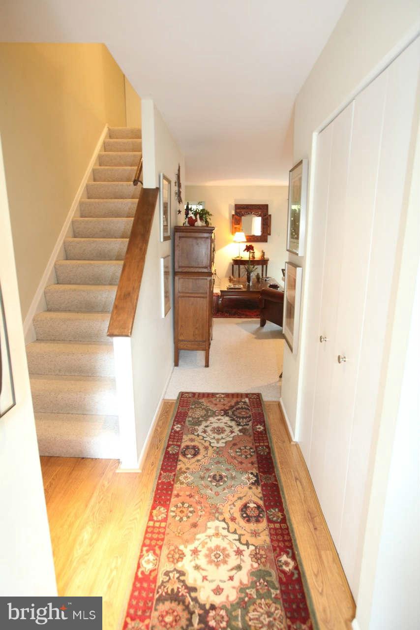 14 Stone Ridge Court, Unit 25 Baltimore, MD 21239 - Photo 2 of 30 a view of a bedroom with wooden floor and stairs