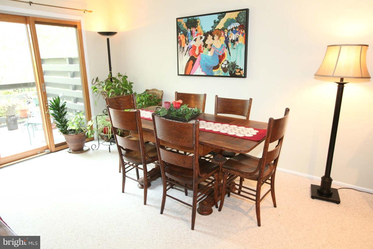 14 Stone Ridge Court, Unit 25 Baltimore, MD 21239 - Photo 12 of 30 a view of a dining room with furniture and a window