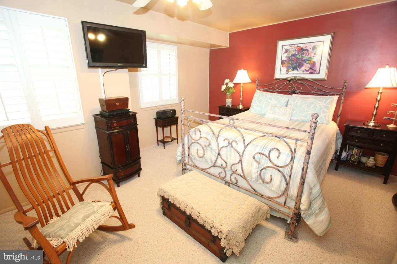 14 Stone Ridge Court, Unit 25 Baltimore, MD 21239 - Photo 17 of 30 a bedroom with a bed tv and chair