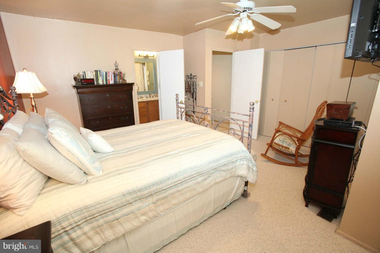 14 Stone Ridge Court, Unit 25 Baltimore, MD 21239 - Photo 19 of 30 a bedroom with a bed and a television