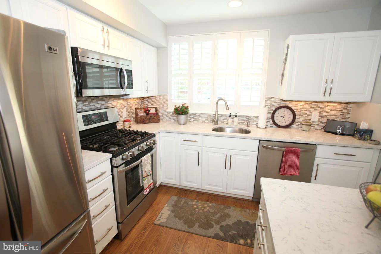 14 Stone Ridge Court, Unit 25 Baltimore, MD 21239 - Photo 3 of 30 a kitchen with granite countertop a sink stove and refrigerator