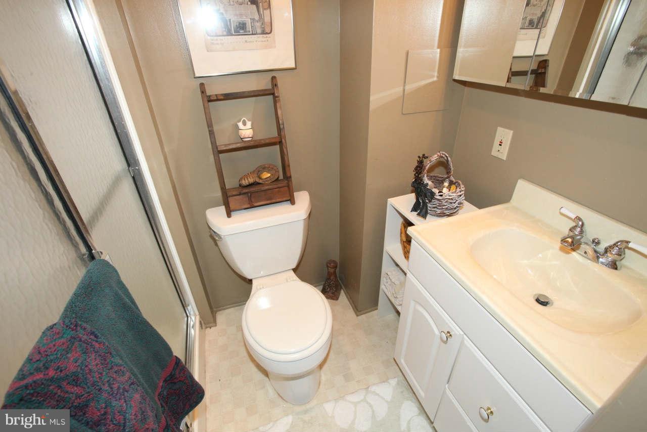 14 Stone Ridge Court, Unit 25 Baltimore, MD 21239 - Photo 22 of 30 a white toilet sitting next to a bathroom sink