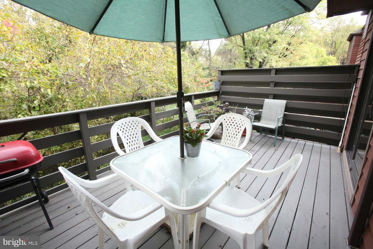 14 Stone Ridge Court, Unit 25 Baltimore, MD 21239 - Photo 24 of 30 a roof deck with a table and chairs