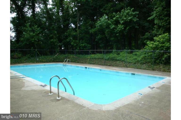 14 Stone Ridge Court, Unit 25 Baltimore, MD 21239 - Photo 27 of 30 a view of a swimming pool with a seating area