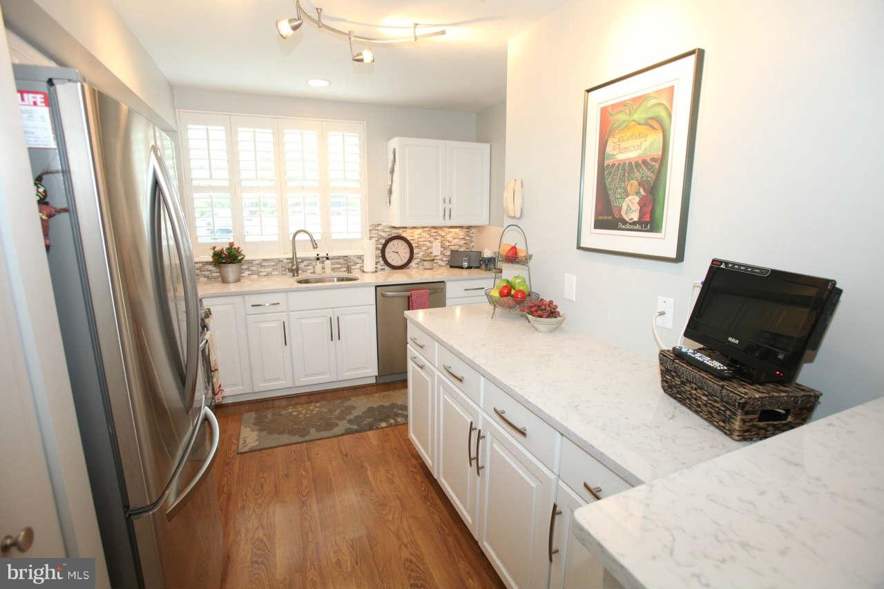 14 Stone Ridge Court, Unit 25 Baltimore, MD 21239 - Photo 4 of 30 a kitchen with a refrigerator a stove top oven and a refrigerator