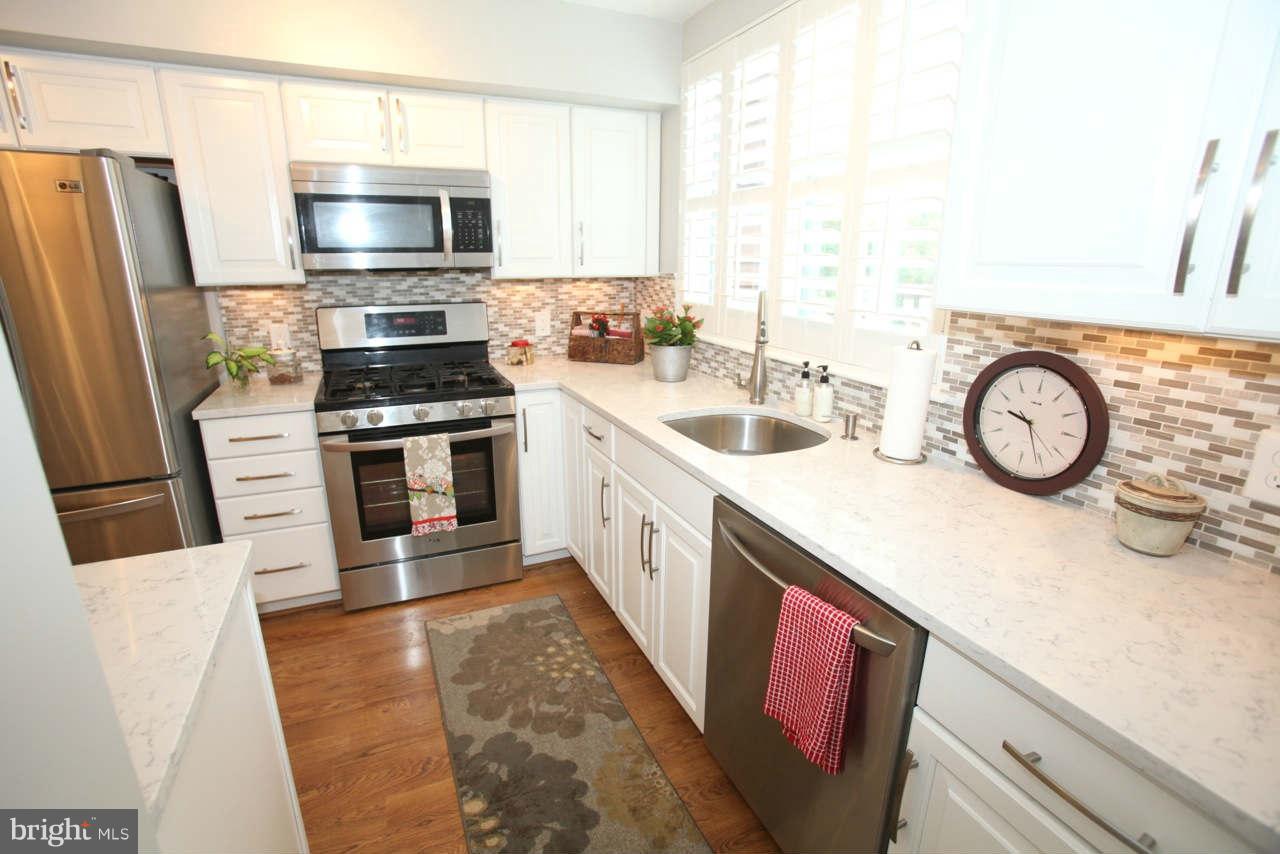 14 Stone Ridge Court, Unit 25 Baltimore, MD 21239 - Photo 5 of 30 a kitchen with a sink stove and refrigerator